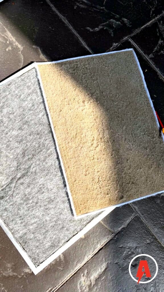 Dust-caked ducted aircon filter next to a cleaned filter
