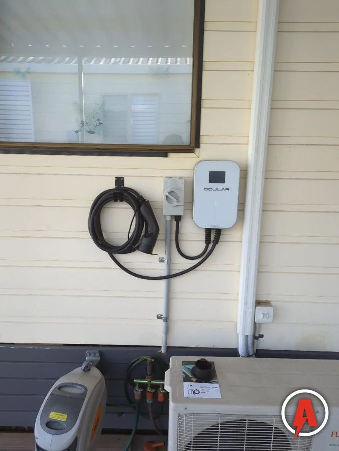 Ocular EV wall charger with isolator installed on a weatherboard wall by Armitage Electrical